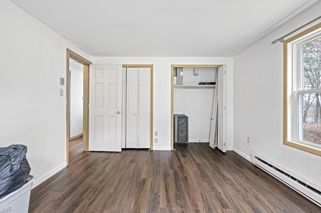 47 Lake Road Brookfield, MA 01506 - Photo 17 of 29 an empty room with wooden floor and windows