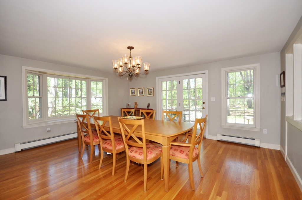 12 Rambling Road Sudbury, MA 01776 - Photo 8 of 26 a view of a dining room with furniture wooden floor and chandelier