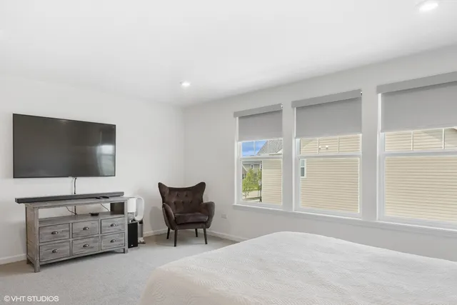 a bedroom with furniture and a flat screen tv