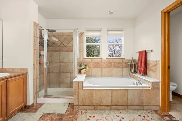 a white bath tub sitting next to a glass door shower