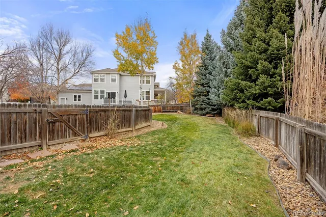 a view of a house with a wooden fence