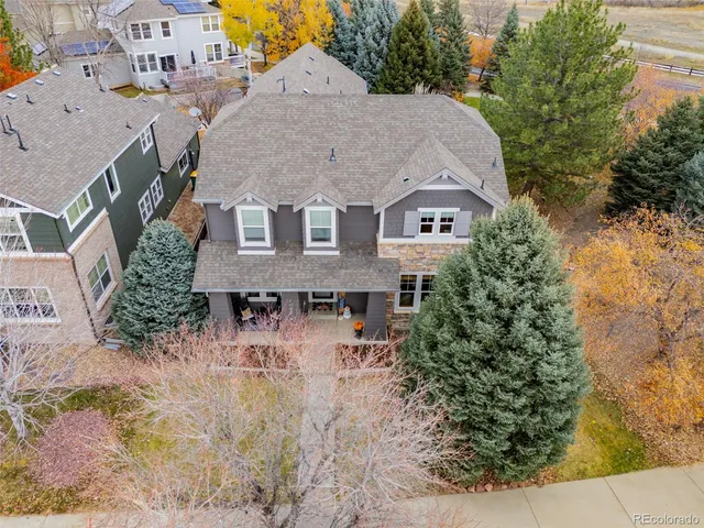 an aerial view of a house with a yard and trees