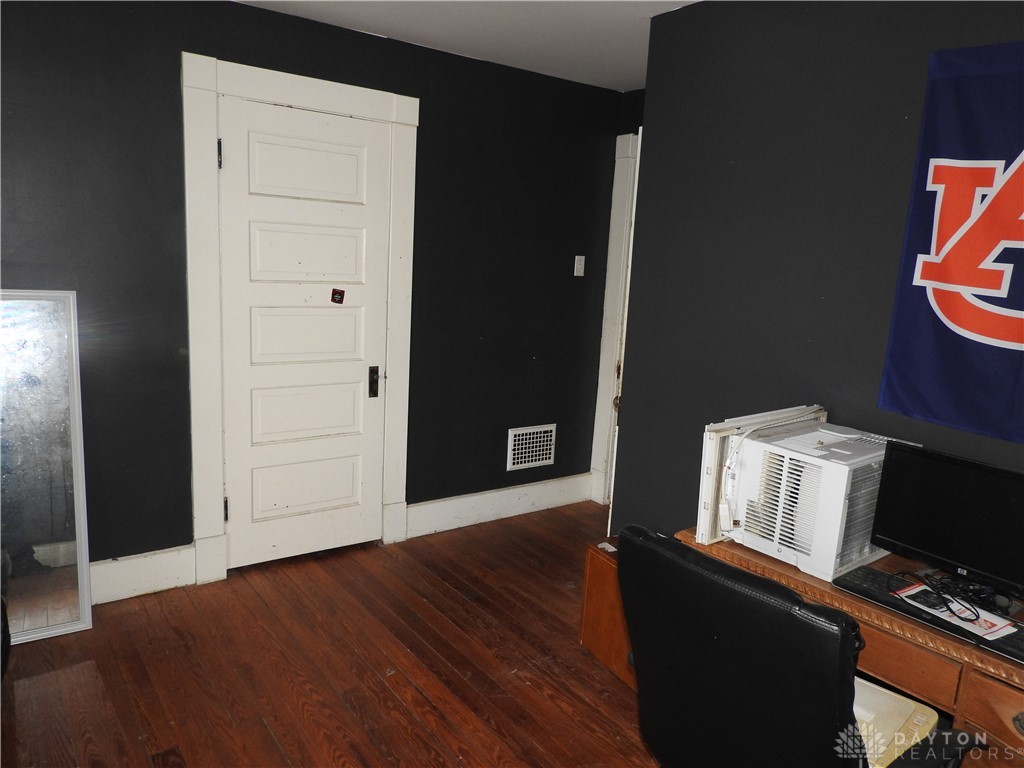 2105 East Loy Road Piqua, OH 45356 - Photo 24 of 26 This versatile room features warm hardwood floors, a classic panel door, and ample wall space.