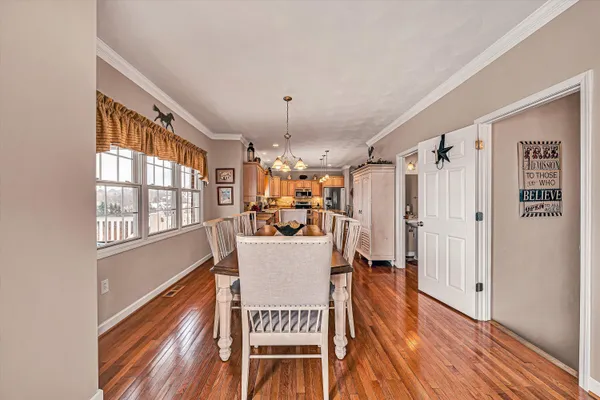 a view of a dining room with furniture window and wooden floor