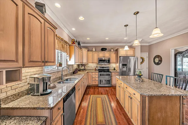 a bedroom with a bed wooden floor and a window