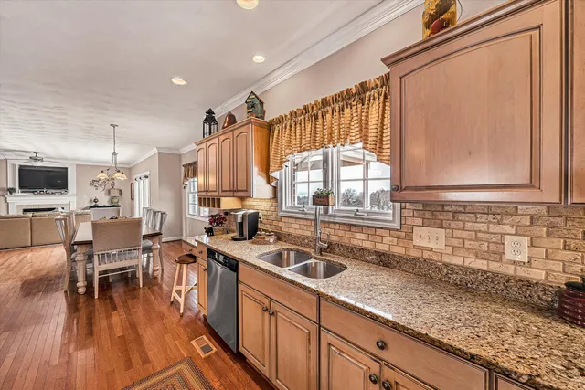 a bathroom with a toilet a sink and a window