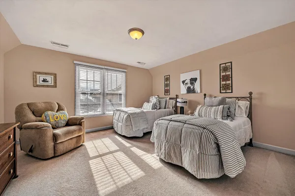 a living room with furniture gym equipment and a chandelier