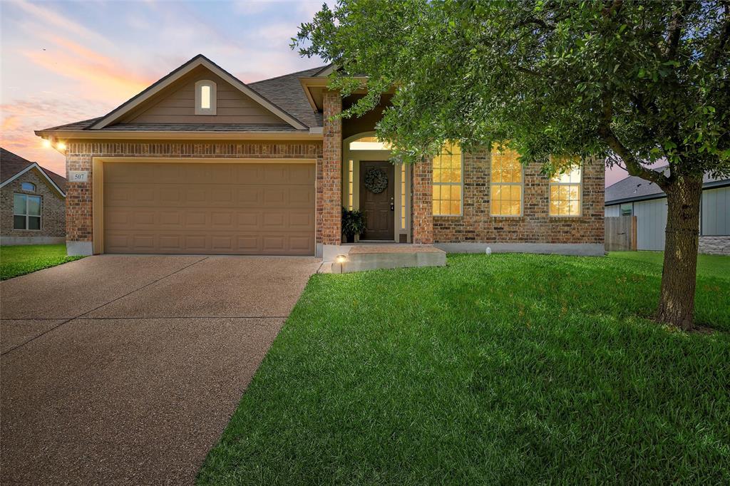 507 Navajo Trail McGregor, TX 76657 - Photo 1 of 1 a front view of a house with a yard and garage