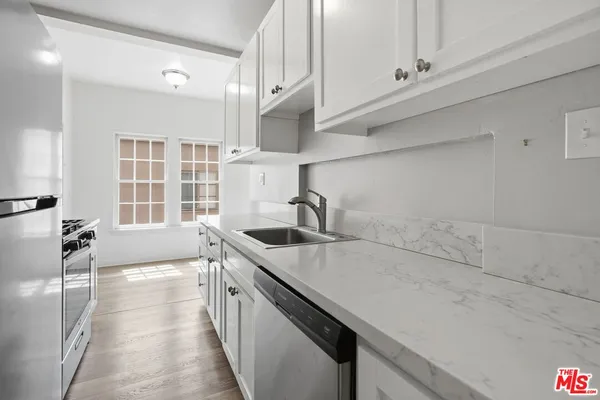 a kitchen that has a sink and a stove