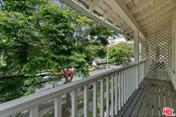 a view of a balcony with flower plants