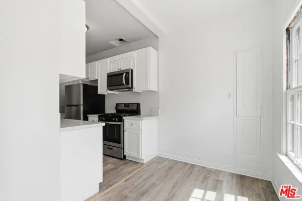 a kitchen with a refrigerator stove and microwave