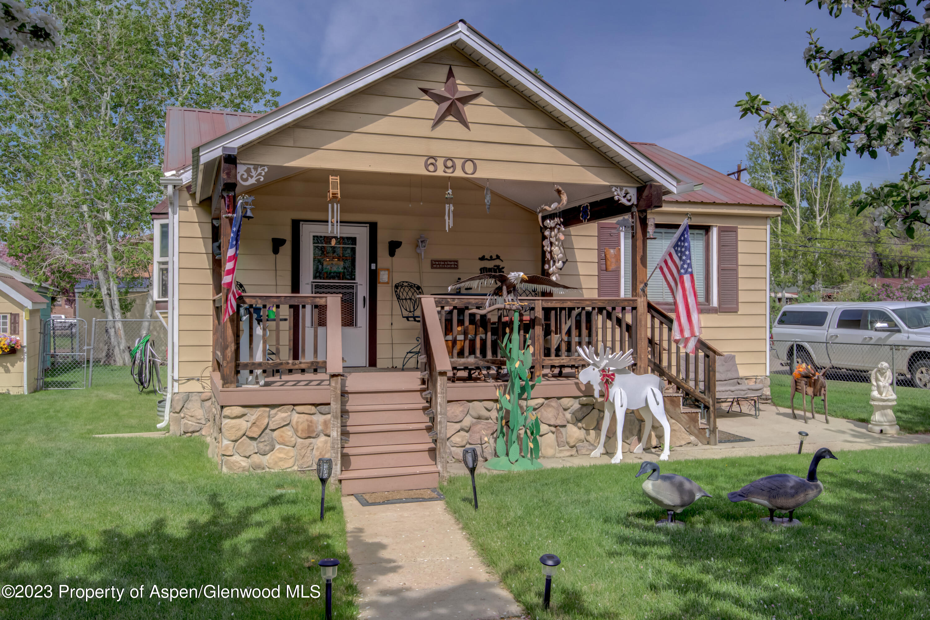 690 Pershing Street Craig, CO 81625 - Photo 13 of 72 a view of a house with a small yard and potted plants
