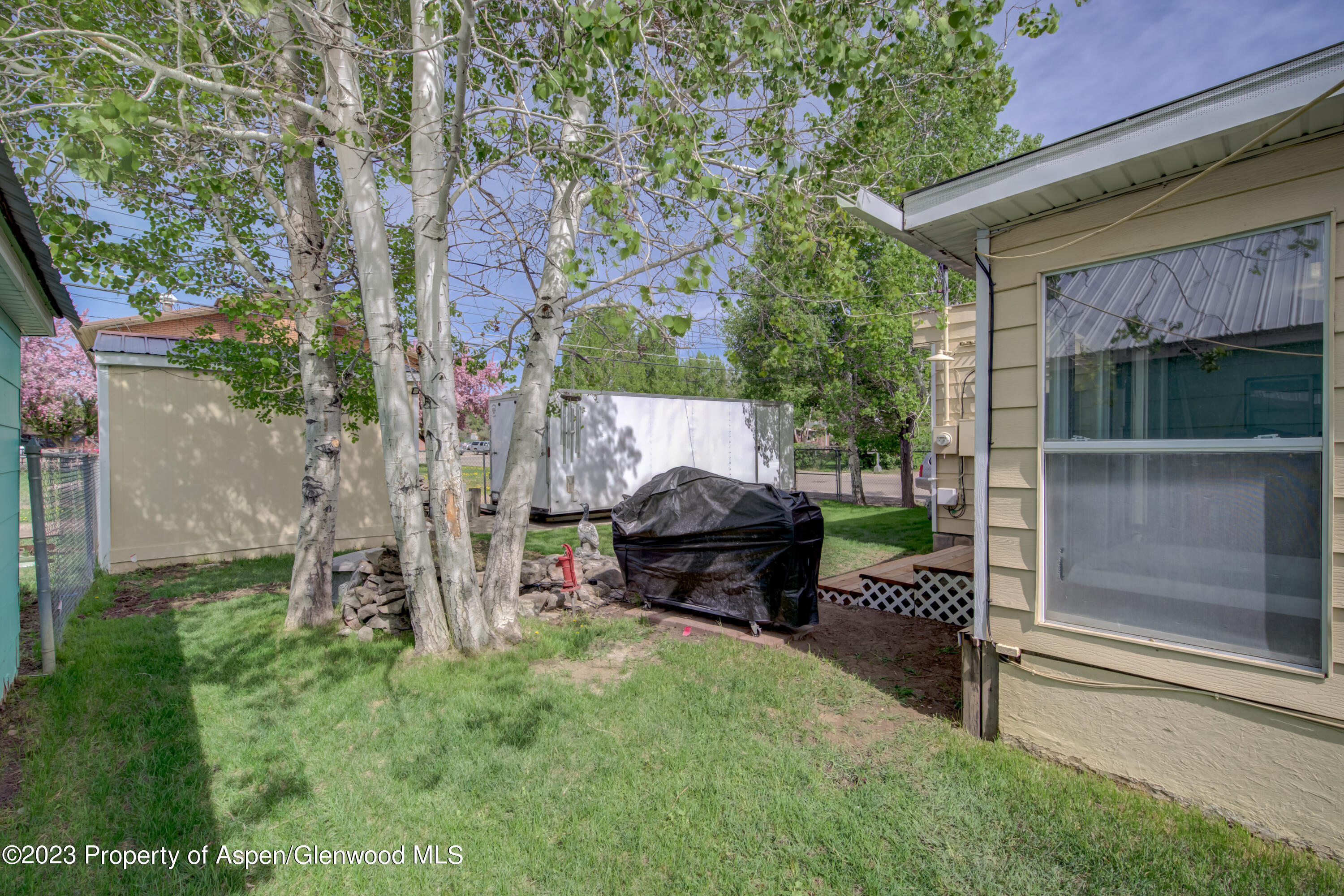 690 Pershing Street Craig, CO 81625 - Photo 16 of 72 a backyard of a house with table and chairs