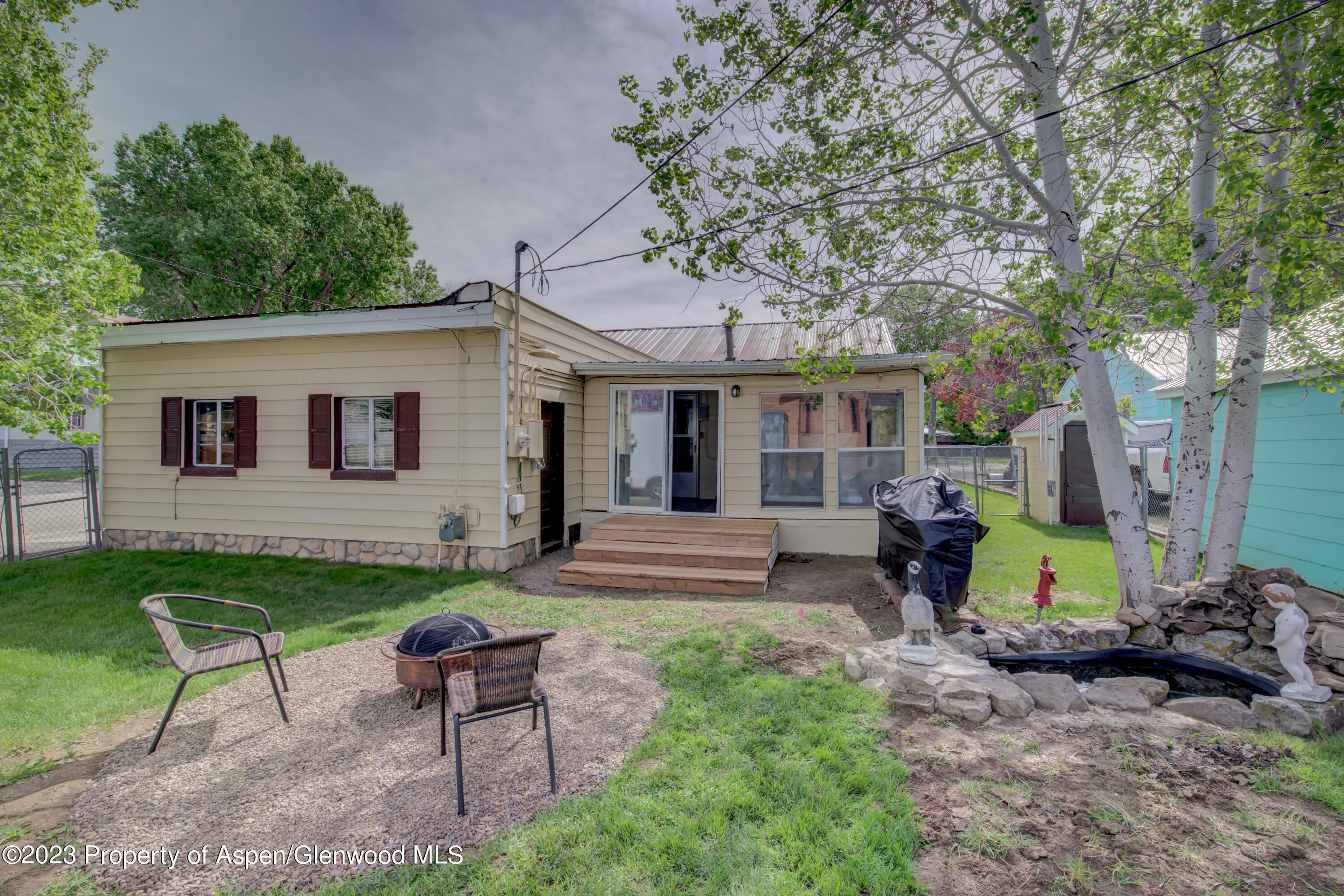690 Pershing Street Craig, CO 81625 - Photo 18 of 72 a view of a house with backyard sitting area and garden