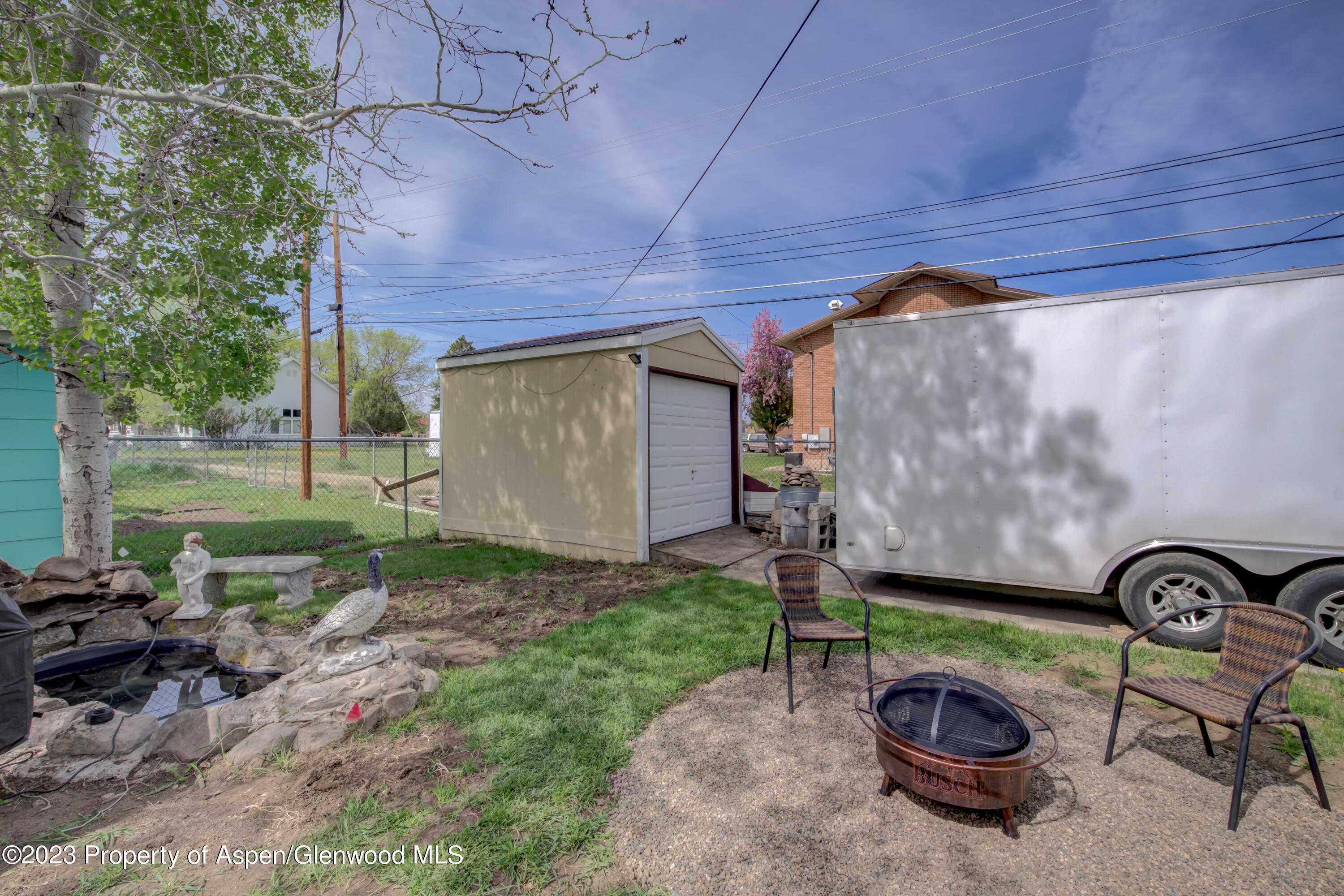 690 Pershing Street Craig, CO 81625 - Photo 20 of 72 a view of a backyard with table and chairs