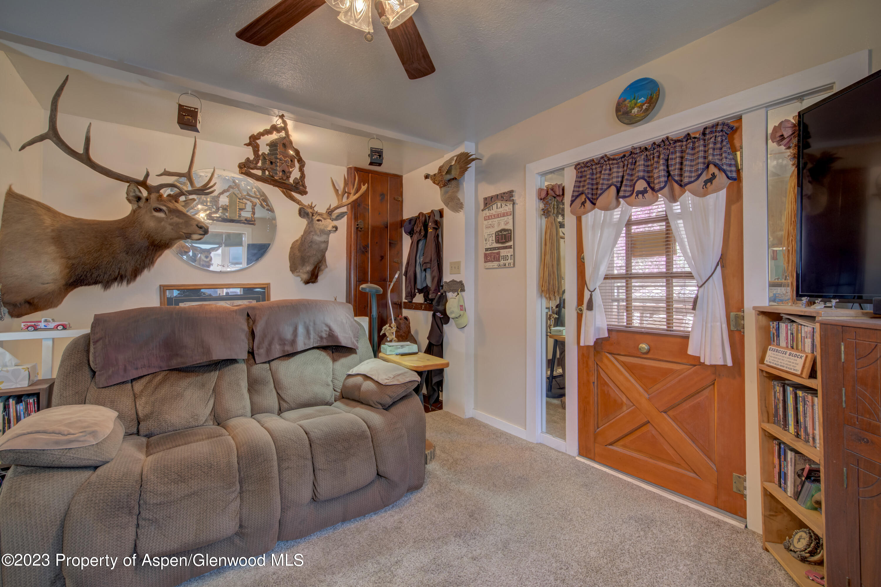 690 Pershing Street Craig, CO 81625 - Photo 27 of 72 a living room with furniture and a flat screen tv
