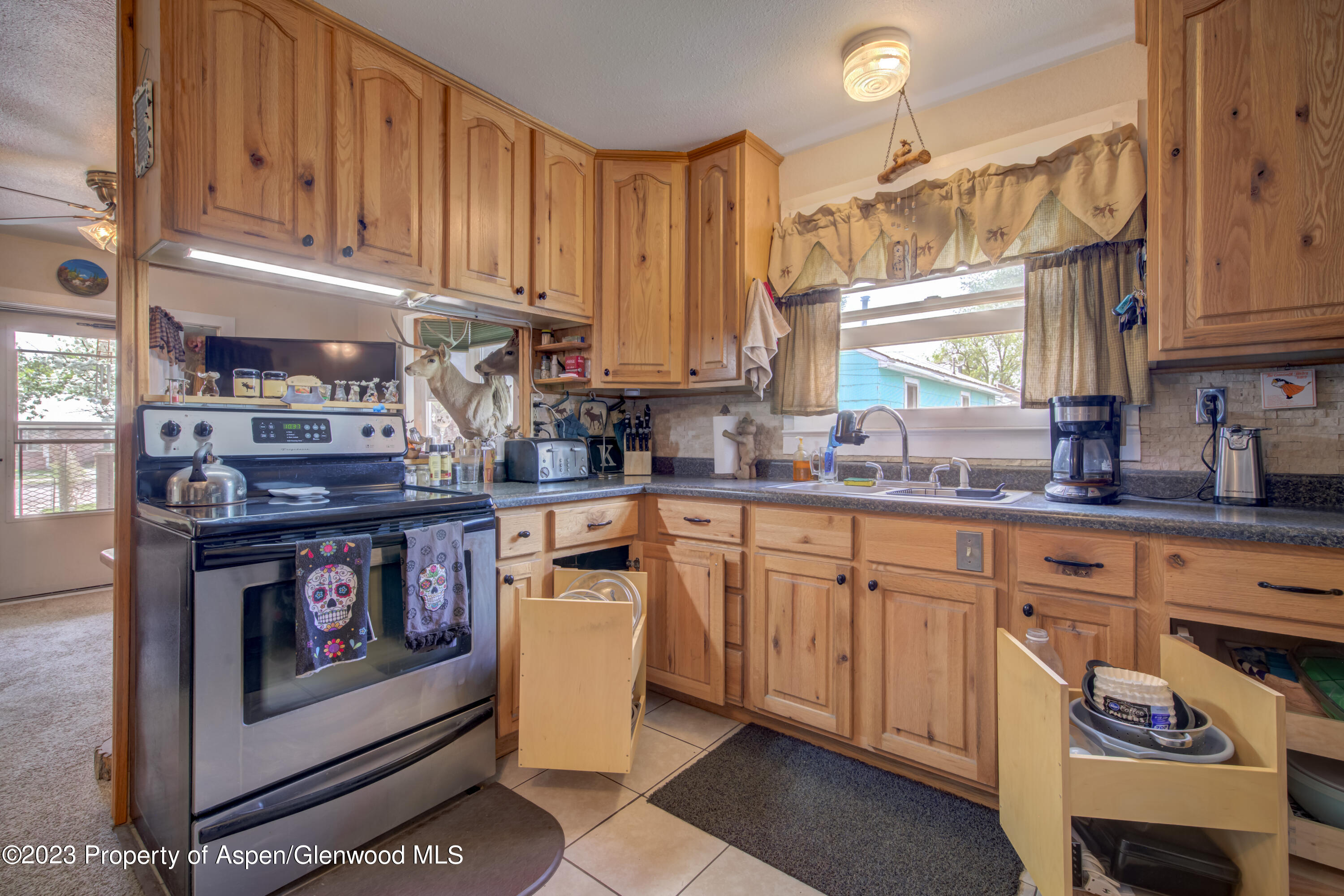 690 Pershing Street Craig, CO 81625 - Photo 29 of 72 a kitchen with stainless steel appliances granite countertop a stove a sink and a microwave