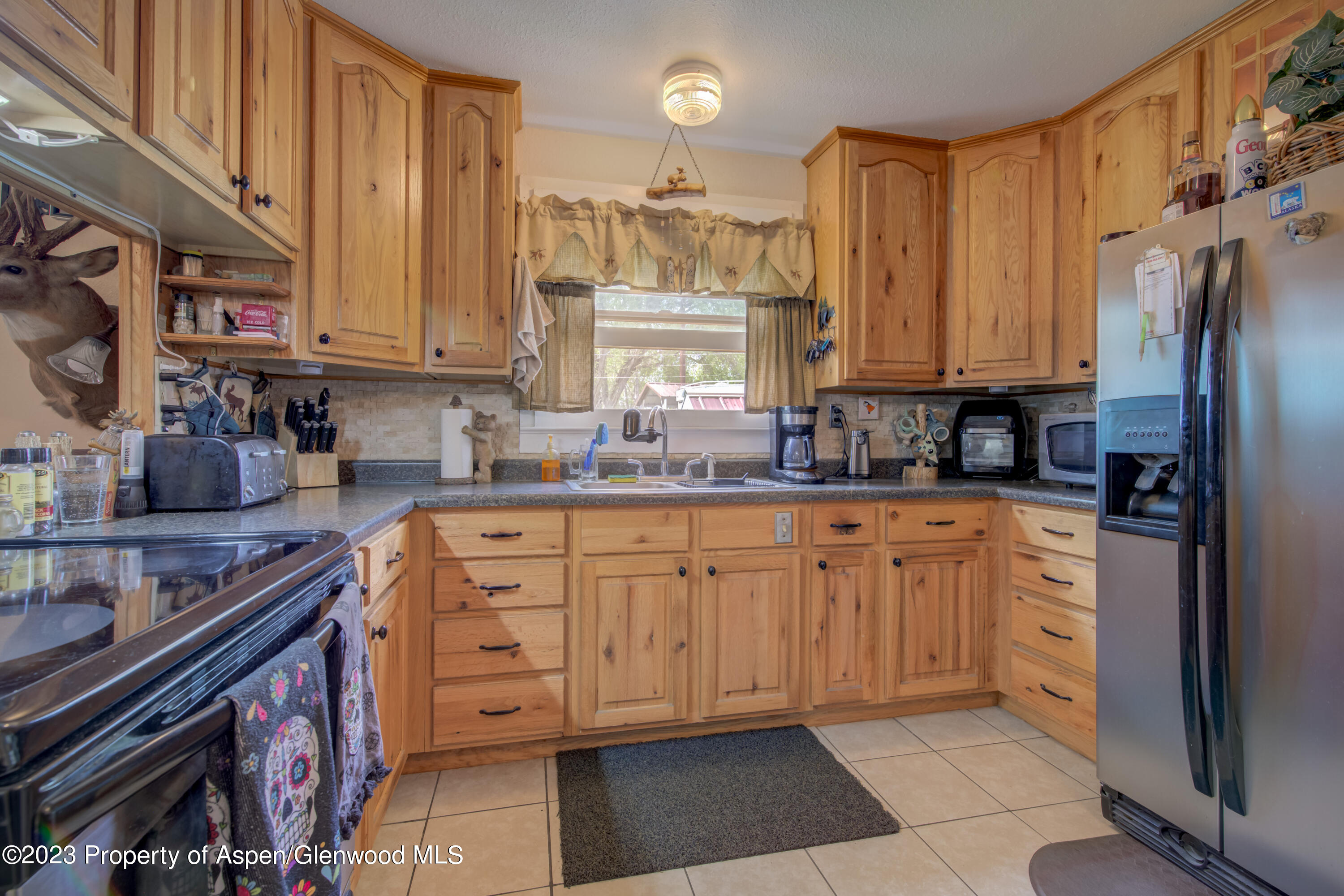 690 Pershing Street Craig, CO 81625 - Photo 31 of 72 a kitchen with stainless steel appliances granite countertop a stove a sink and a refrigerator