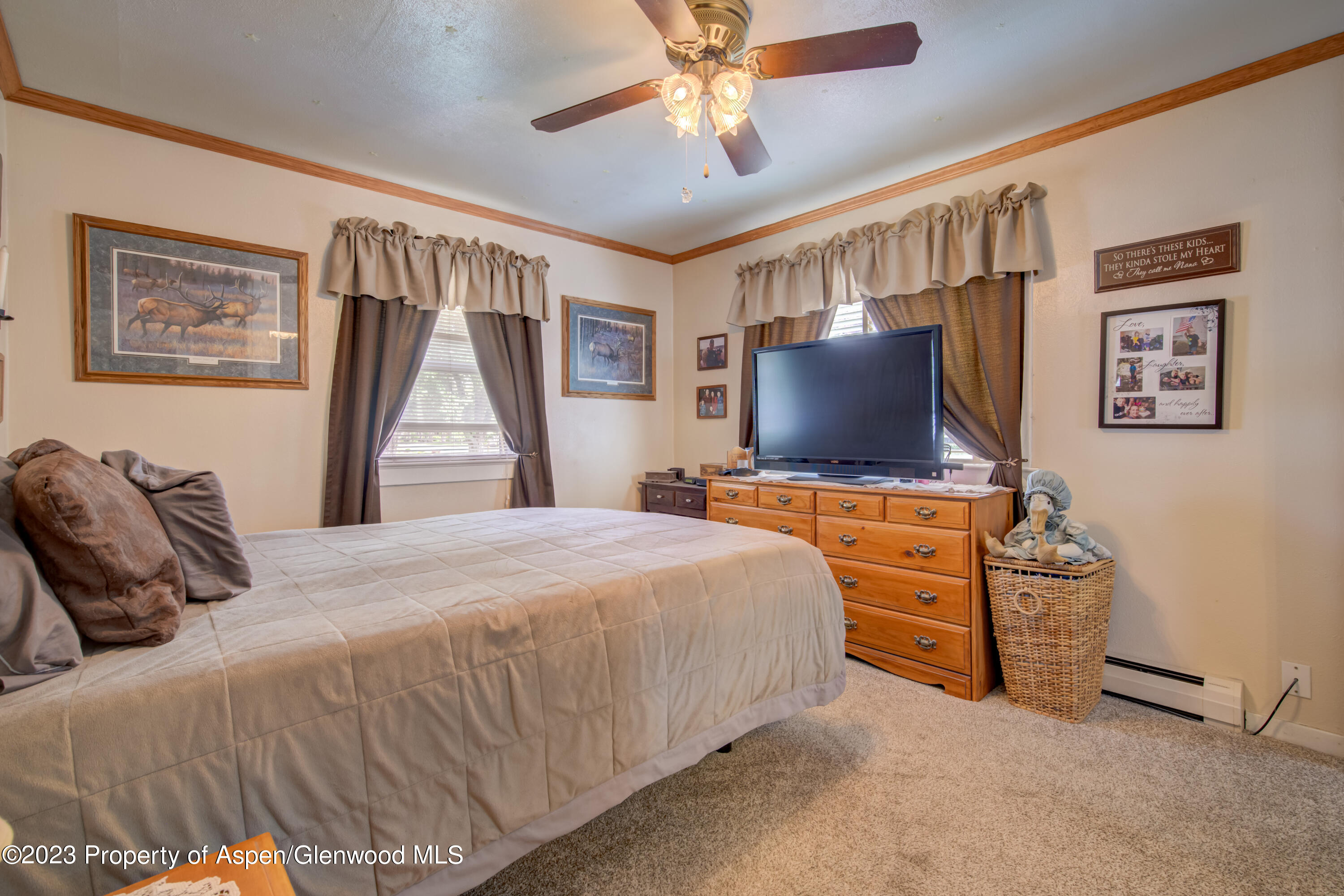 690 Pershing Street Craig, CO 81625 - Photo 37 of 72 a bedroom with a bed and a flat tv screen on dresser