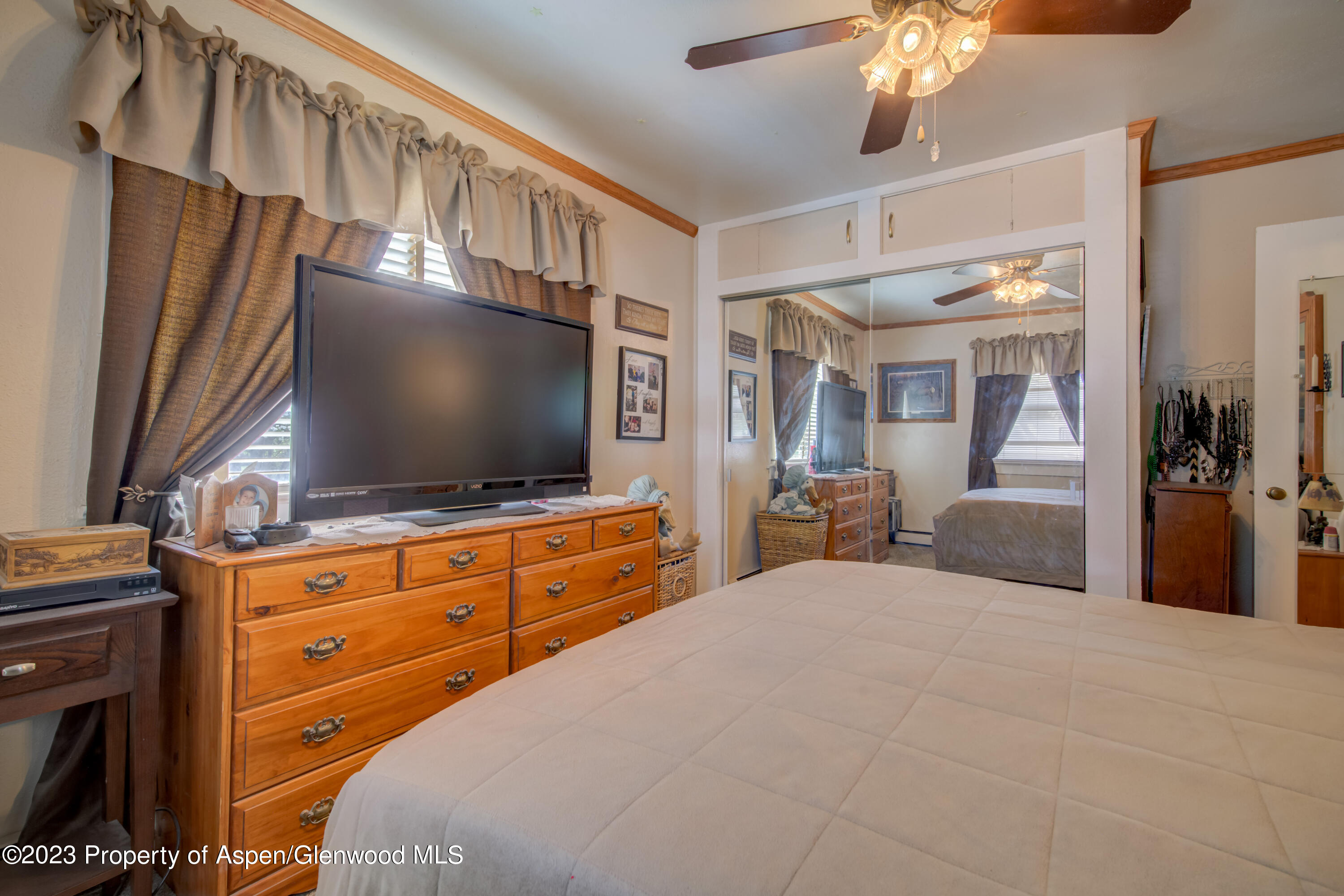 690 Pershing Street Craig, CO 81625 - Photo 40 of 72 a bedroom with a bed and a flat screen tv