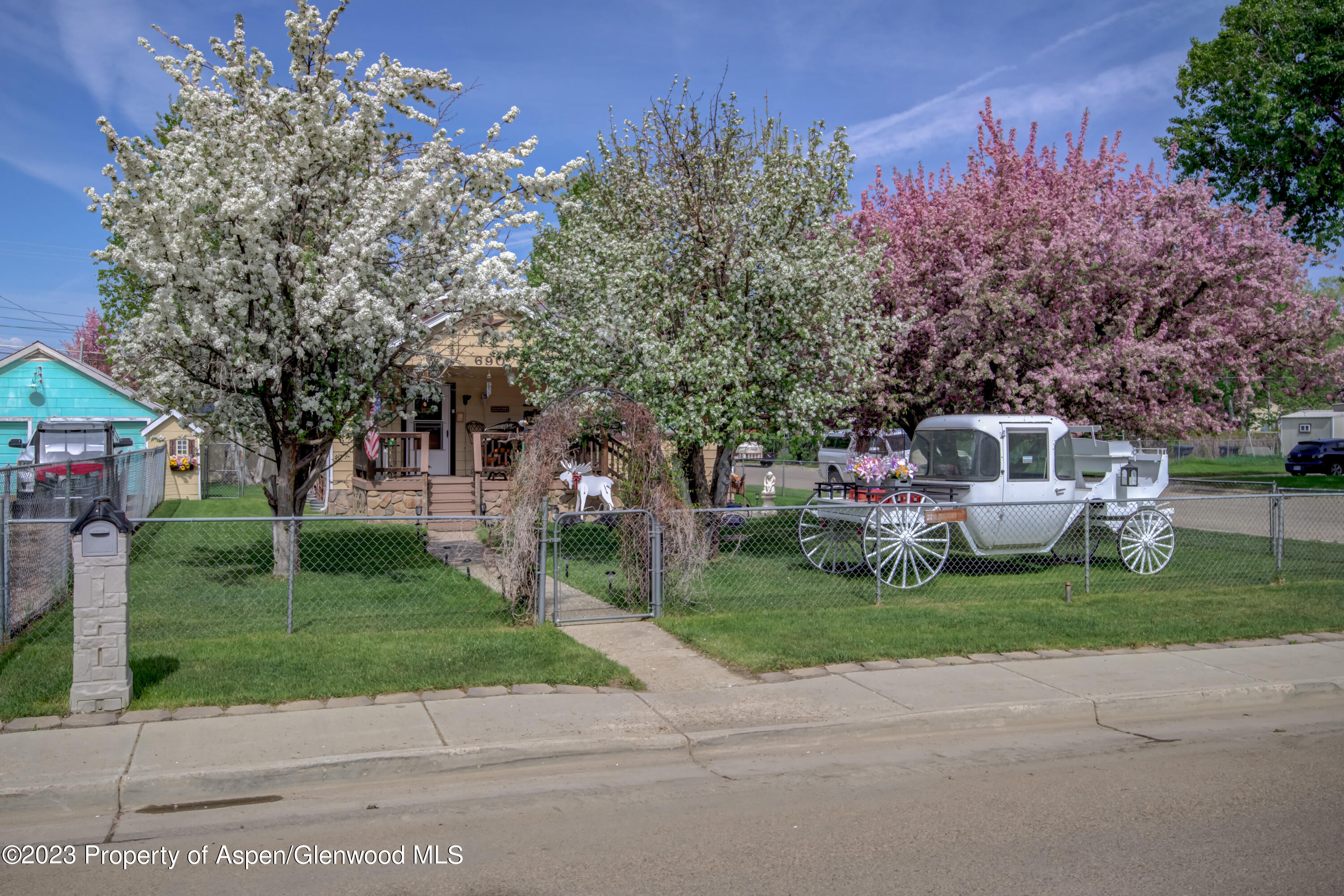 690 Pershing Street Craig, CO 81625 - Photo 4 of 72 a front view of a house with a garden and trees