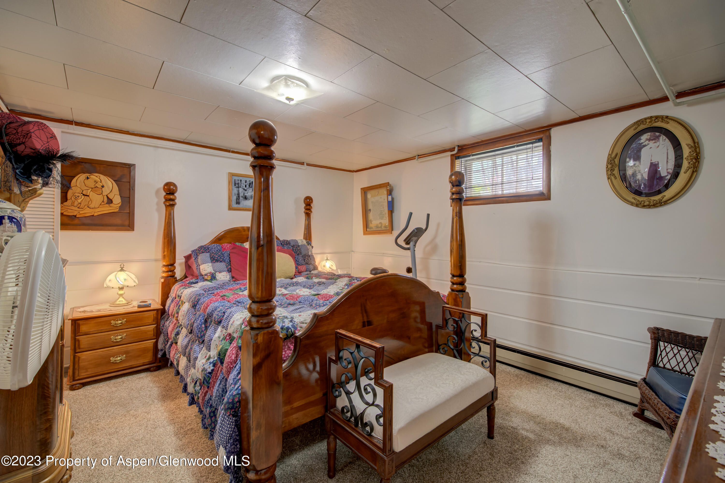 690 Pershing Street Craig, CO 81625 - Photo 68 of 72 a bedroom with a bed and a chandelier
