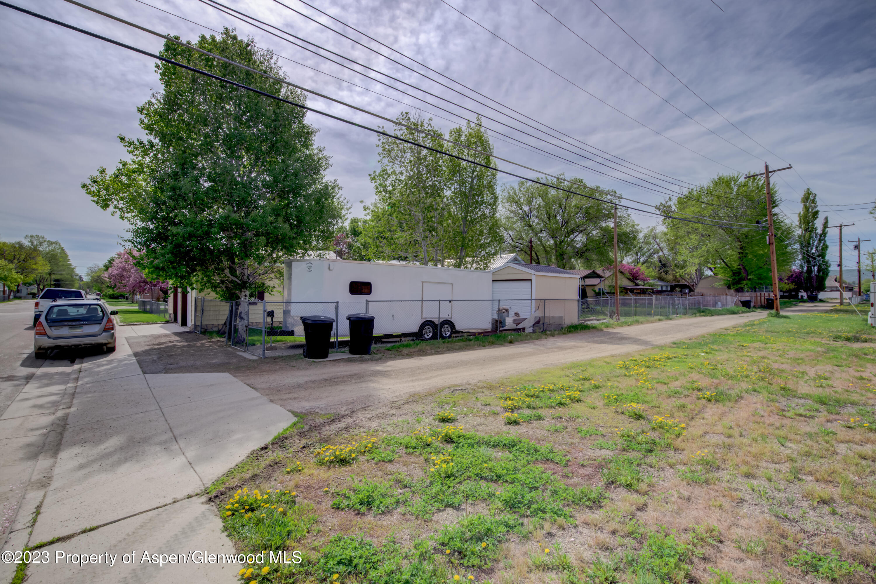 690 Pershing Street Craig, CO 81625 - Photo 10 of 72 a couple of cars parked in front of yellow house