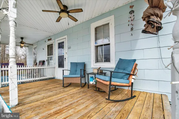 a bedroom with furniture and wooden floor