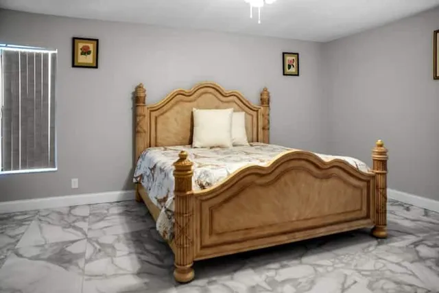 a bedroom with a bed and a window