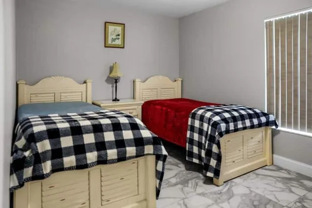 a bedroom with a bed and window