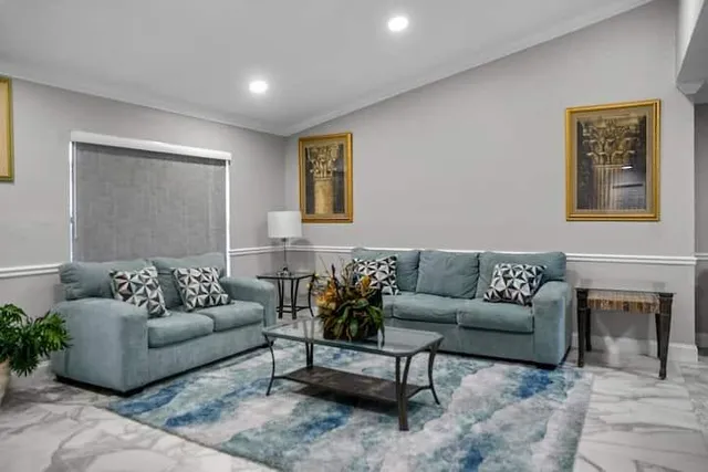 a living room with furniture and a fireplace