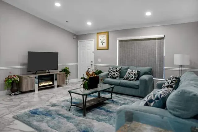 a living room with furniture and a flat screen tv