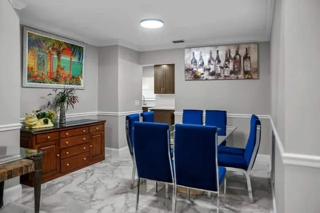 a living room with furniture and painting on the wall