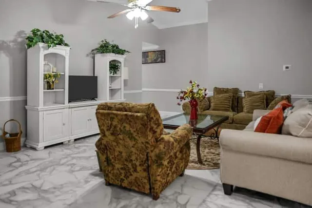 a living room with furniture and flowers