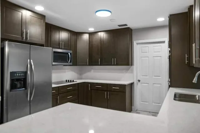 a kitchen with stainless steel appliances a refrigerator and a sink