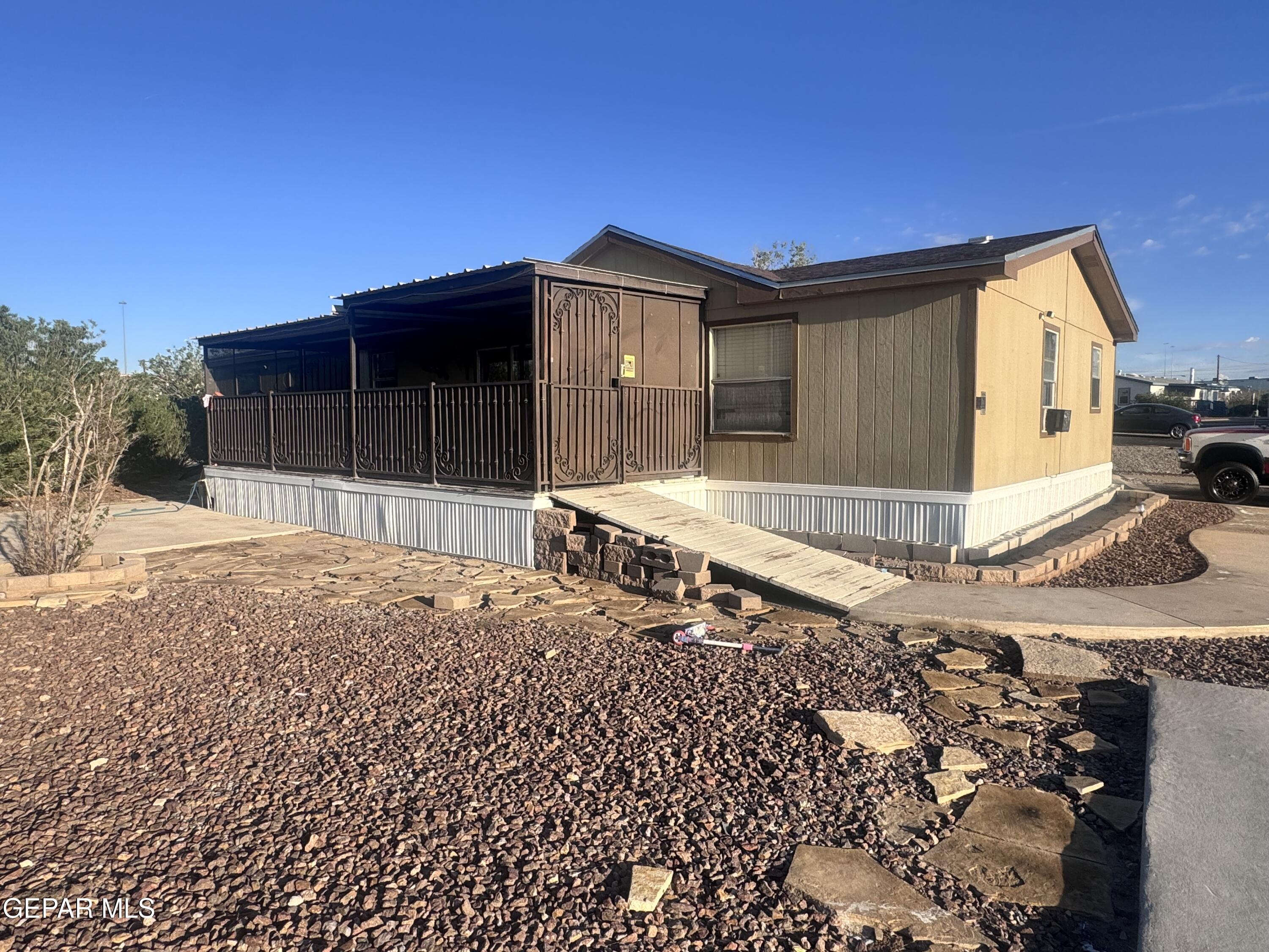 12400 Rojas Drive El Paso, TX 79928 - Photo 2 of 11 a backyard of a house with glass top table and chairs