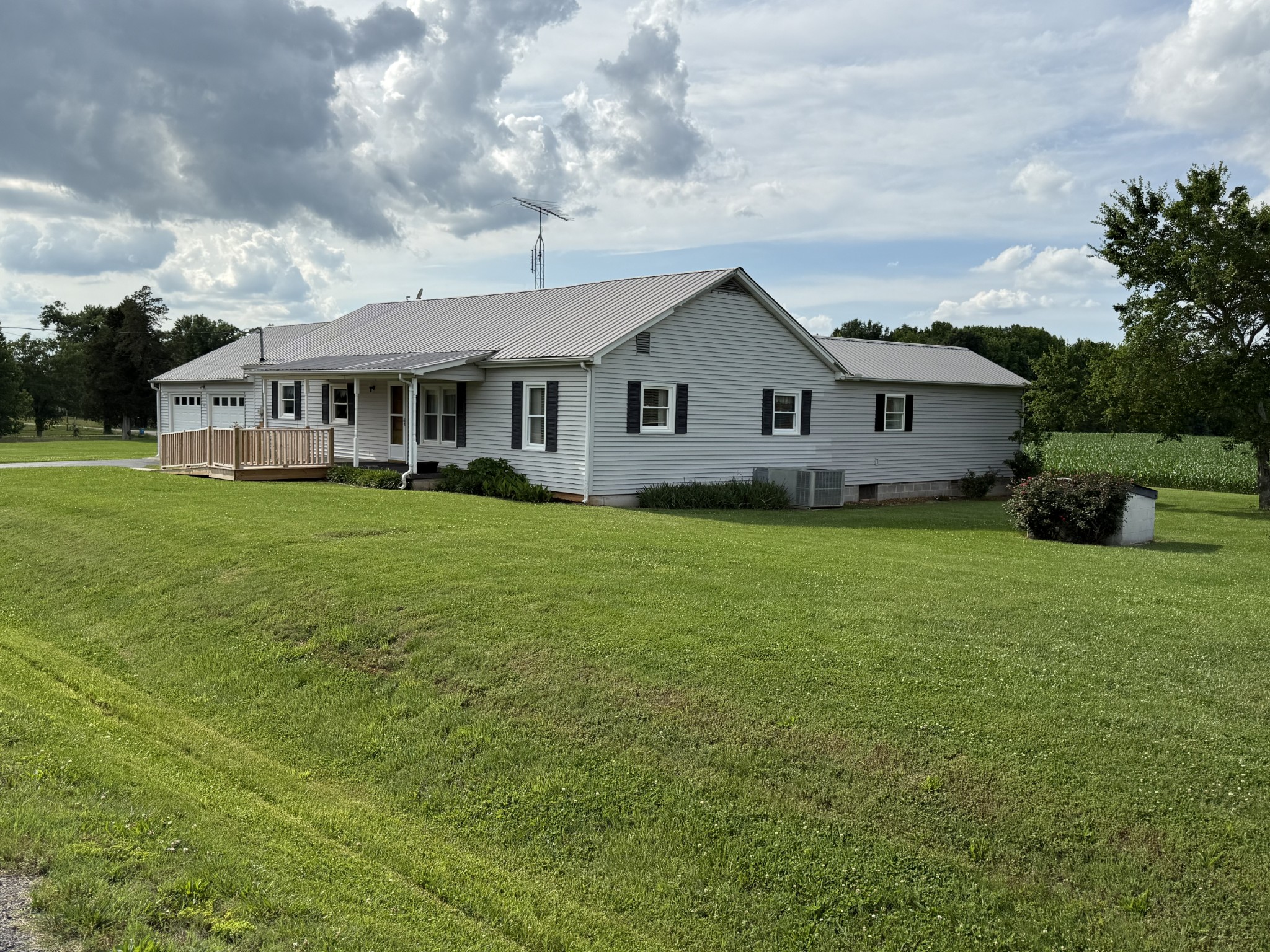 2971 Monroe Floyd Road Decherd, TN 37324 - Photo 26 of 26 a view of a house with a big yard and potted plants and large trees