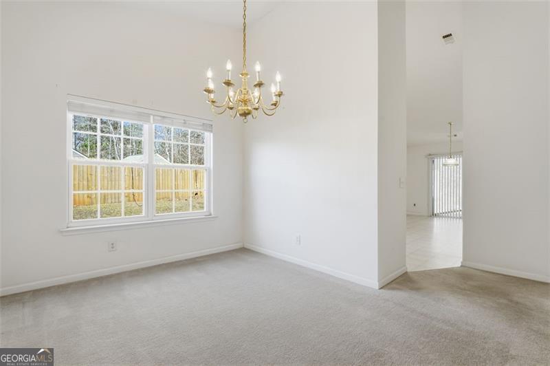 6214 Tree Ridge Dr N West Acworth, GA 30101 - Photo 13 of 41 an empty room with a chandelier