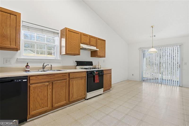 6214 Tree Ridge Dr N West Acworth, GA 30101 - Photo 14 of 41 a kitchen with stainless steel appliances granite countertop a sink and cabinets with wooden floor