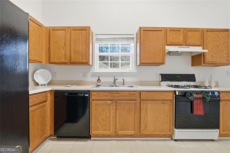 6214 Tree Ridge Dr N West Acworth, GA 30101 - Photo 15 of 41 a kitchen with stainless steel appliances granite countertop a stove a sink and a microwave