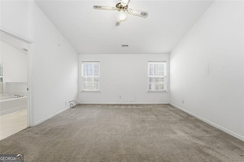 6214 Tree Ridge Dr N West Acworth, GA 30101 - Photo 33 of 41 an empty room with a ceiling fan and a window