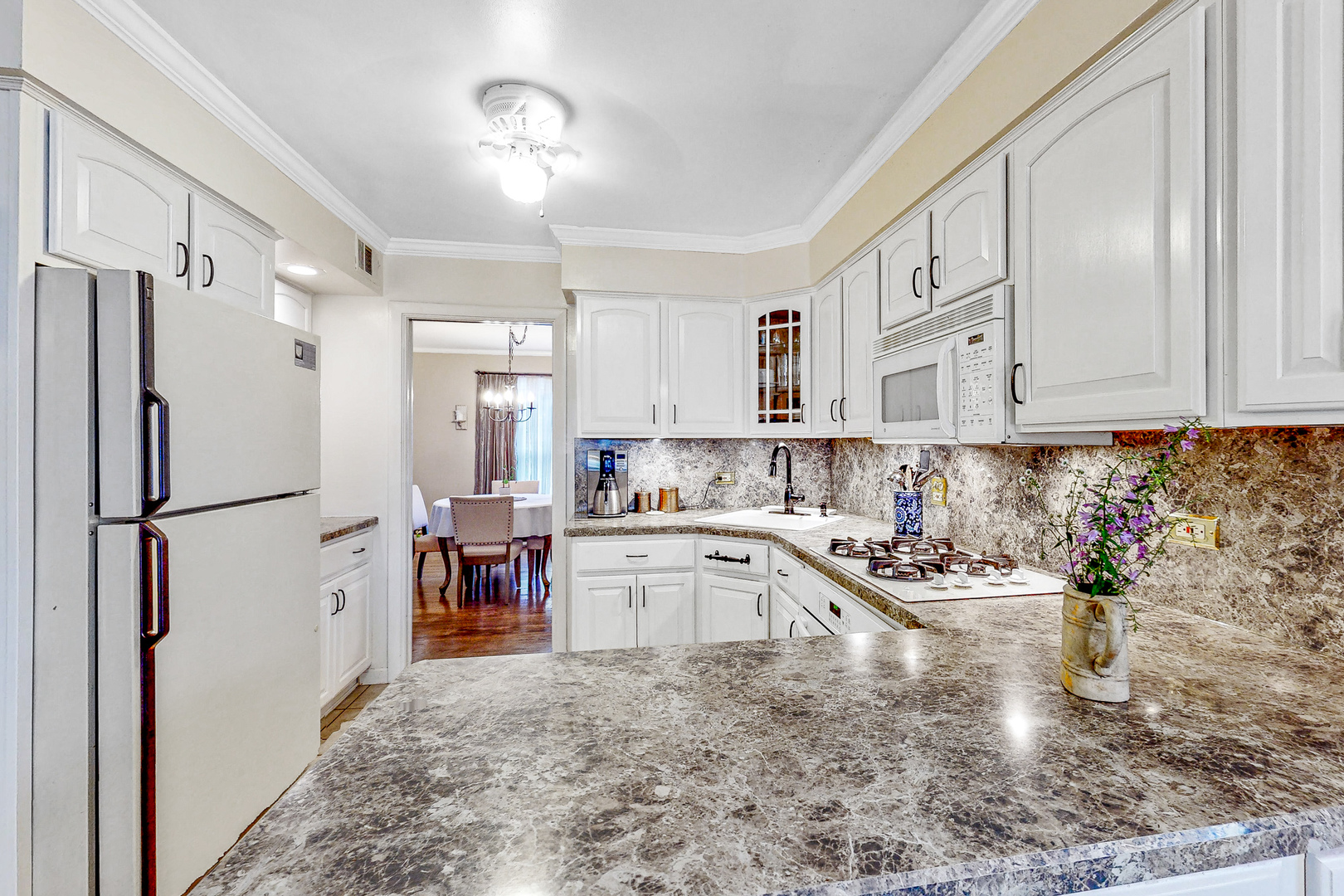 823 South Western Avenue Park Ridge, IL 60068 - Photo 10 of 39 a kitchen with granite countertop a refrigerator a sink and white cabinets