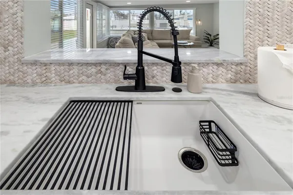 a kitchen with granite countertop a sink stove and cabinets