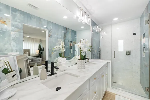 a bathroom with a granite countertop sink a toilet and a mirror