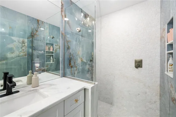 a bathroom with a sink a toilet and shower curtain