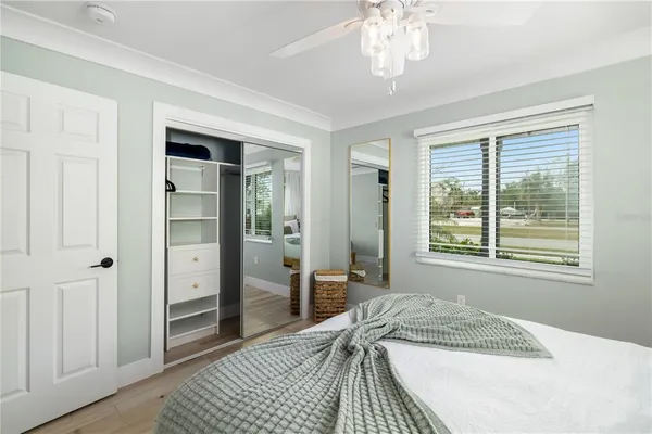 a spacious bathroom with a granite countertop sink a mirror a bathtub and shower