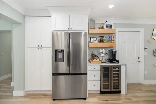 a kitchen with stainless steel appliances a refrigerator and a stove top oven