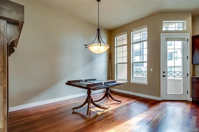 a view of a room with furniture wooden floor and a chandelier