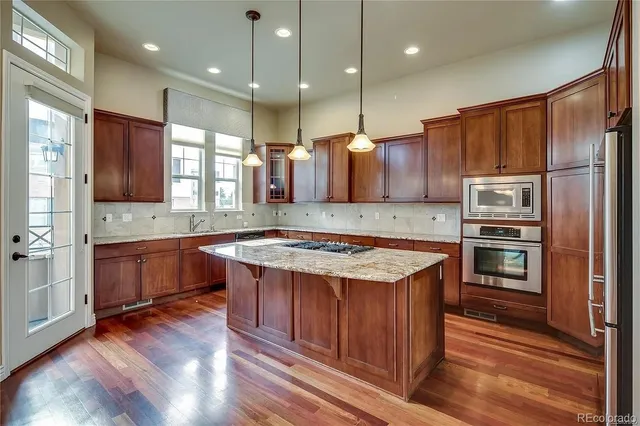 a kitchen with a sink stove and refrigerator