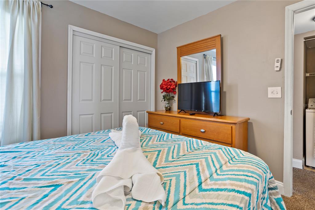 2749 North Poinciana Boulevard, Unit 15 Kissimmee, FL 34746 - Photo 14 of 36 a bedroom with a bed and a window
